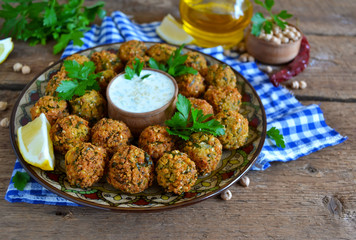 Falafel - deep fried balls of ground chickpeas with tahini sauce from