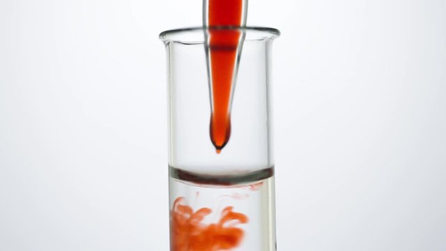 A pipette drips blood into a test tube