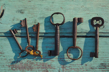 Skeleton keys on top of an old wooden surface. Backgrounds and textures