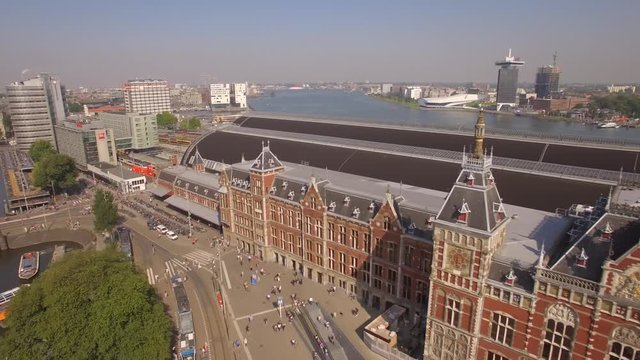 Amsterdam aerial sightseeing. Flying near central train station. 4K