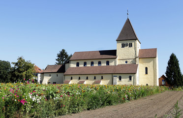 A German Village Church and Tower with wildflower meadow