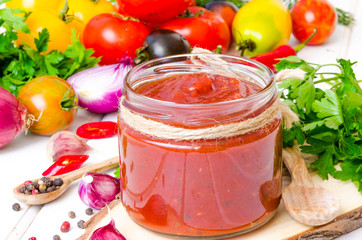 homemade spicy tomato sauce or ketchup on a white background