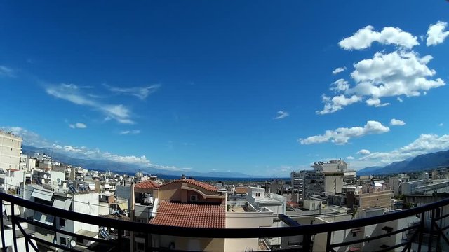 time-lapse of fast moving clouds in the sky over a city (x100) 