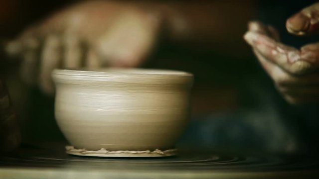 Potter's wheel real-time footage: a process of making of clay bowl