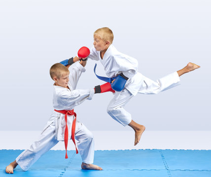 Karate athletes train punch in jump and block