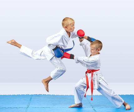 Punch arm in the jump and block are training boys in karategi