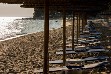 Sunshades and sunbeds on the beach and blue sky