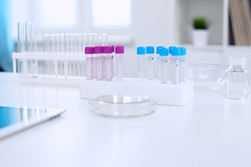 Research laboratory working space. Test tubes and tablet PC are lying at the table. Medical equipment. Blood test