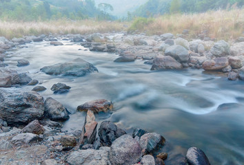 River water flowing through rocks at dawn, Sikkim, India