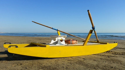 Obraz na płótnie Canvas Yellow rescue boat on Italian beach. Adriatic sea.
