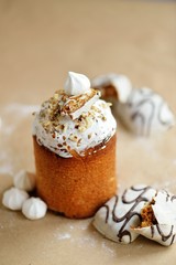 Easter holiday cake kulich with cream nuts dried fruits chocolate cookies marshmallows on craft background