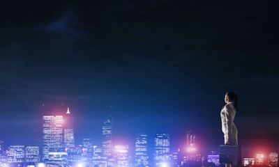 Woman looking at night city