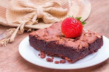 Brownie Cake with strawberry on a wooden floor