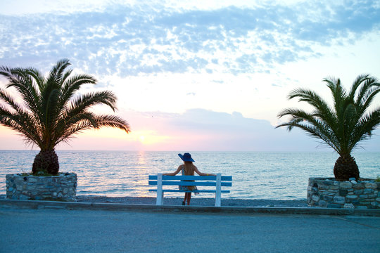girl sits waiting by the sea