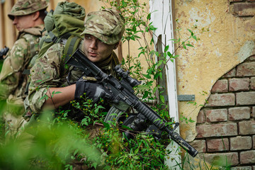 Soldiers on patrol in destroyed city. Military and rescue operation