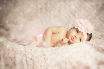 Newborn baby girl with pink tutu.