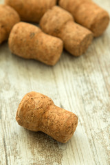 Corks from a champagne bottle on a wooden background