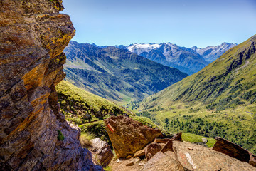 Rock framed view on mountains and valley in Ponte di Legno, Case