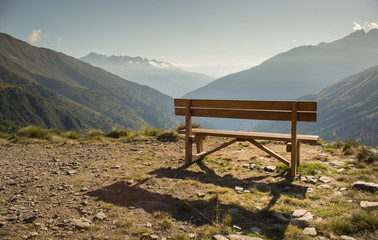 wooden bench in front of amazing view on valley and mountains (P