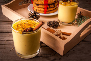 Traditional Christmas drink eggnog on a wooden background  - obrazy, fototapety, plakaty