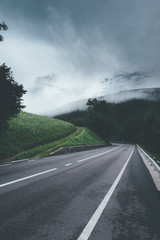 Road in the mountain with clouds and fog