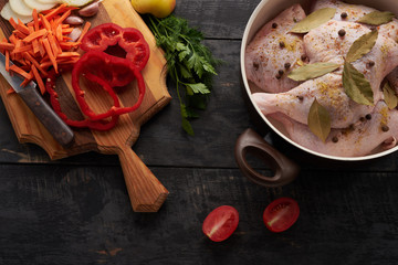 cooking chicken meat, spices and vegetables