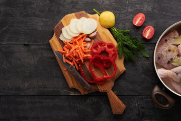 cooking chicken meat, spices and vegetables