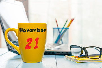 November 21st. Day 21 of month, morning drink cup with calendar on Database Administrator workplace...