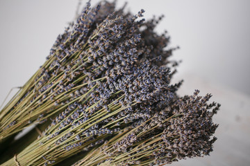 bunches of dried lavender in backet on wooden background