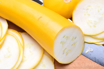 Sliced zucchini and knife on a wooden board, closeup