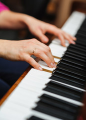 Fototapeta premium woman hands on a piano key