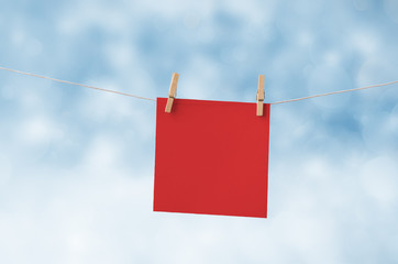Red Christmas Note Paper Pegged to Clothes Line against Snowy Sk