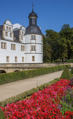 Naklejka premium Red flowers in front of the Neuhaus castle in Paderborn