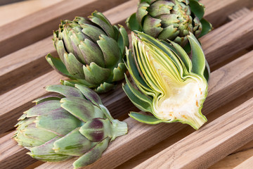 Ripe organic artichokes on the rustic wooden lattice