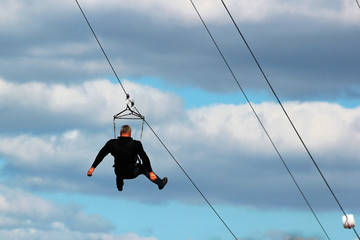 Man descends on a zipline