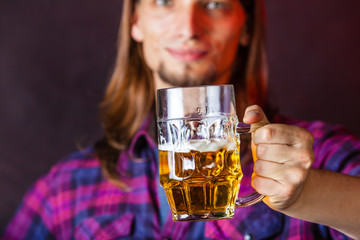 Young man drinking pint.