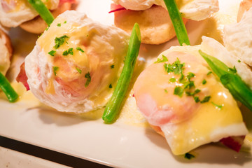 Eggs Benedict- toasted English muffins, ham, poached eggs aspara
