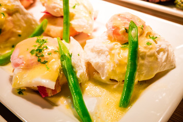 Eggs Benedict- toasted English muffins, ham, poached eggs aspara