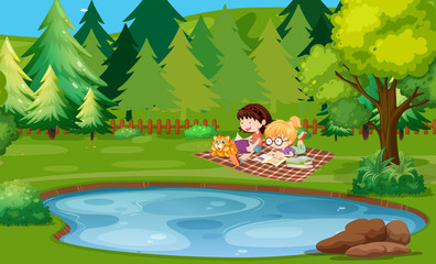 Two girls reading book by the pond