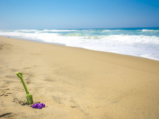 Fototapeta na wymiar Little shovel on beach