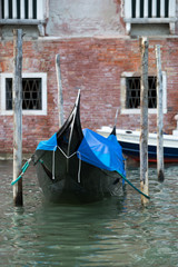 Fototapeta na wymiar Detail of gondola in Venice, Italy. Black boats for turistic passangers in turistic town. Historic boat. 