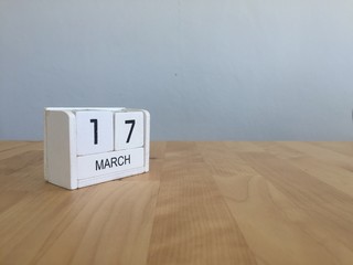 March 17th. March 17 white wooden calendar on vintage wood abstr