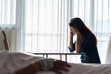 Women strain and worried for her friend in bed health condition in hospital room, select focus
