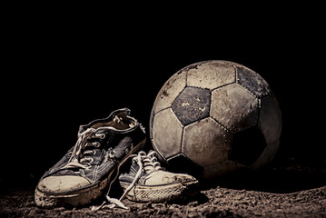 Ragged sneakers with a soccer ball