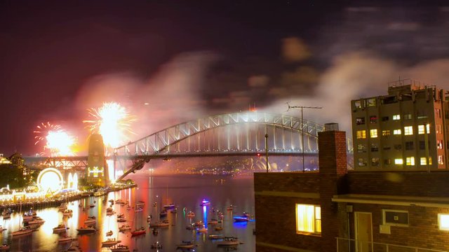 Night scene with New Years Eve fireworks display on Sydney Harbour Bridge. Time lapse
