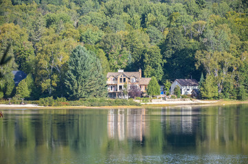 Fototapeta na wymiar Wooden house at Lake, National park, Quebec, Canada