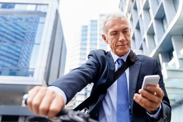 Successful businessman riding bicycle