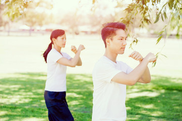 Fototapeta premium People practicing thai chi in park