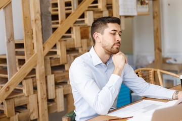 Young man architect in office