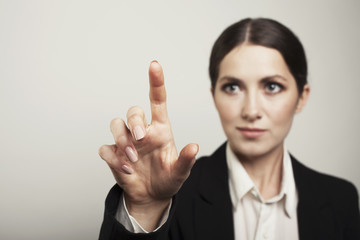 Business woman pushing button face blur isolated